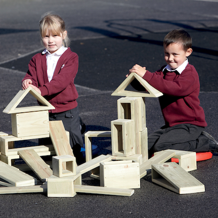 Two children building wooden tower