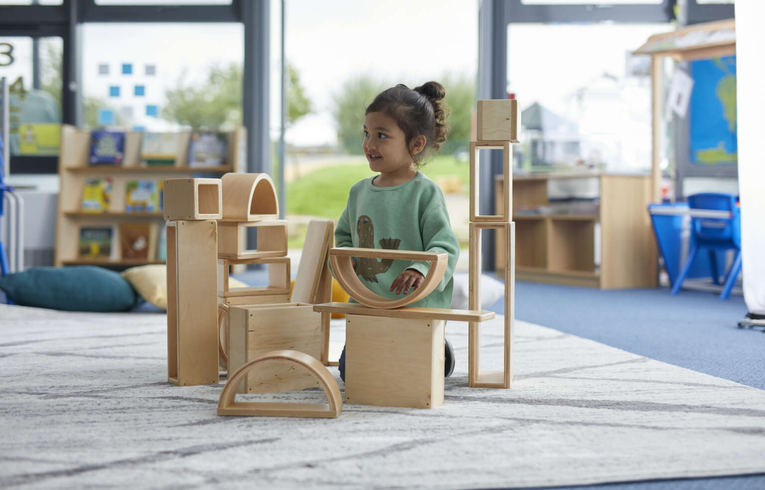 Young girl building with wooden large shapes - Early Years Play