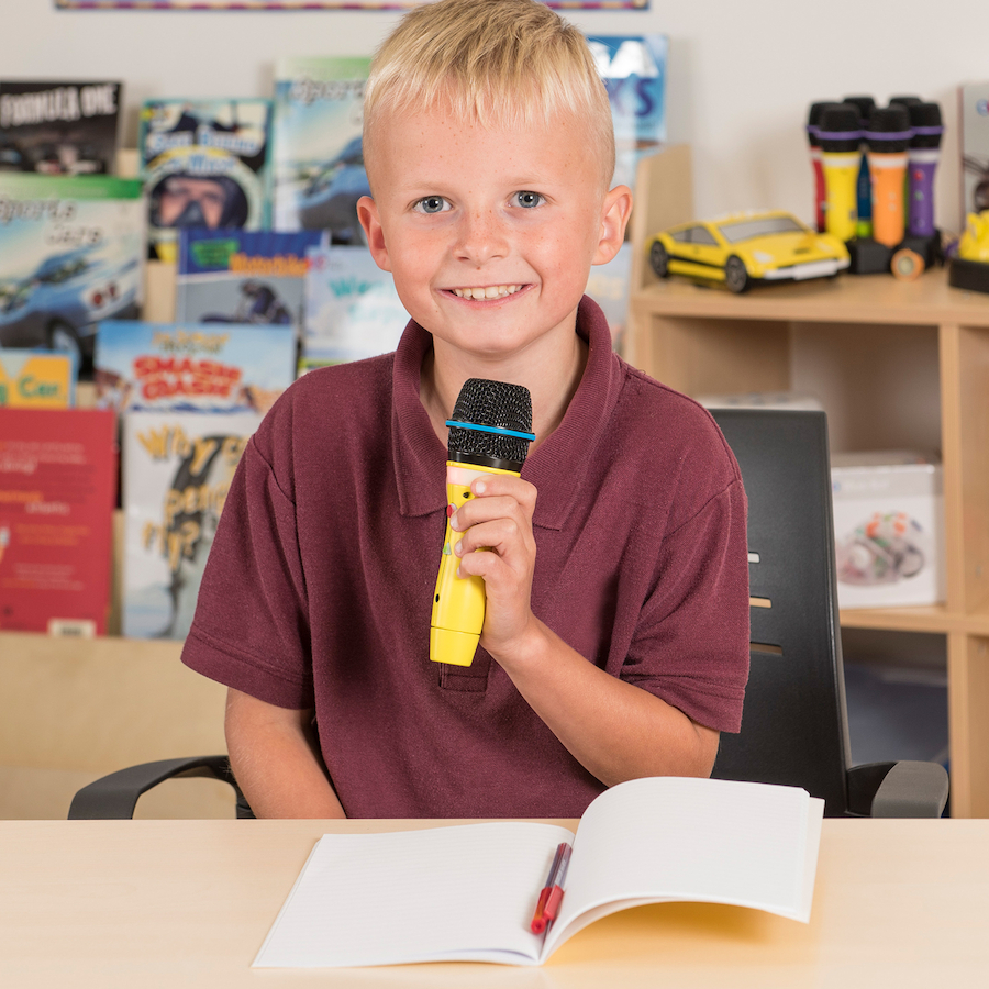 Boy using microphone in classroom
