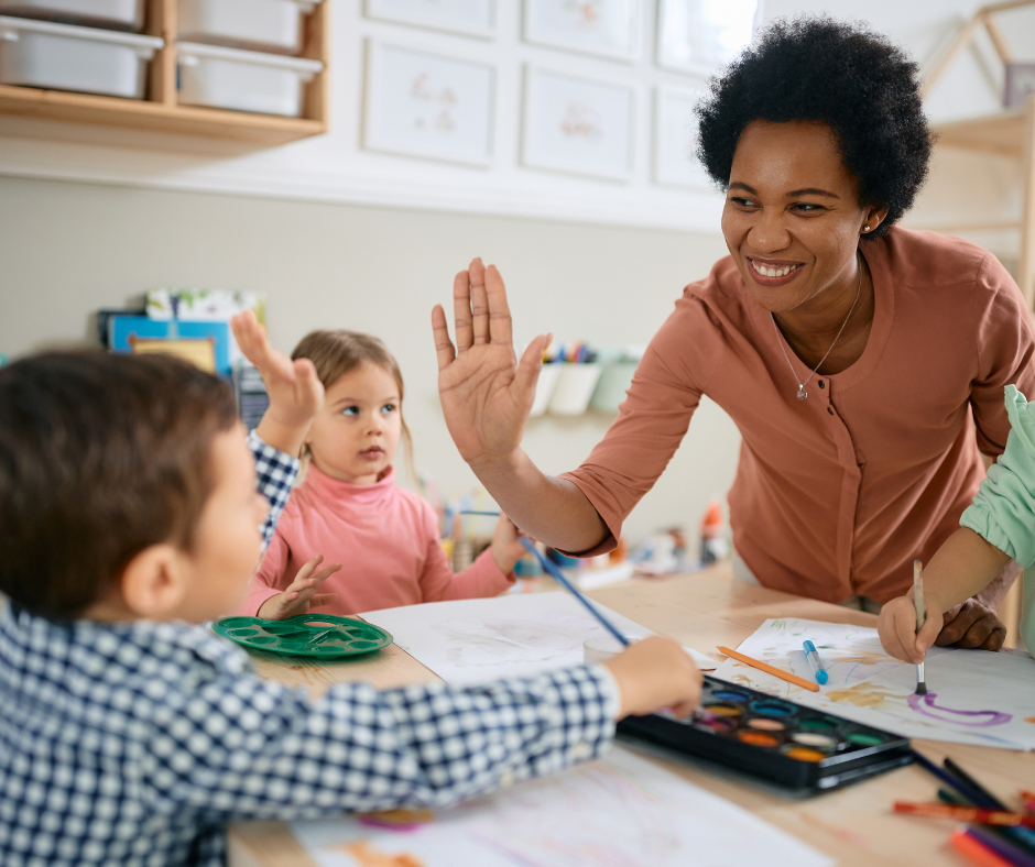 a woman high fiving two children